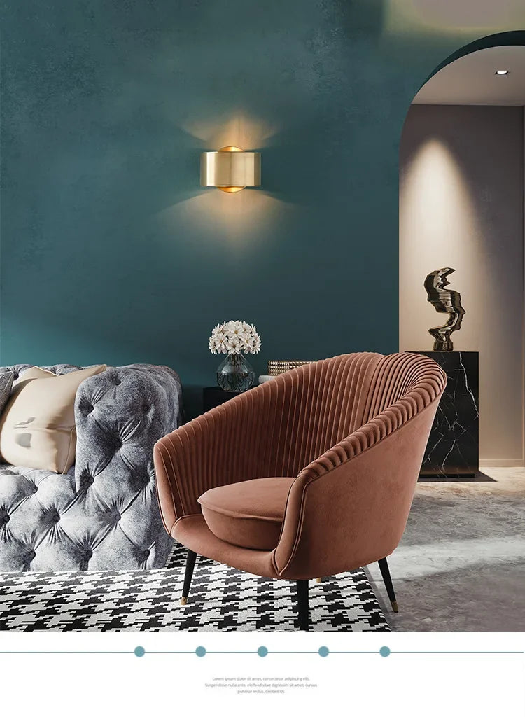 Modern living room with a brown armchair, gray sofa, and decorative elements.