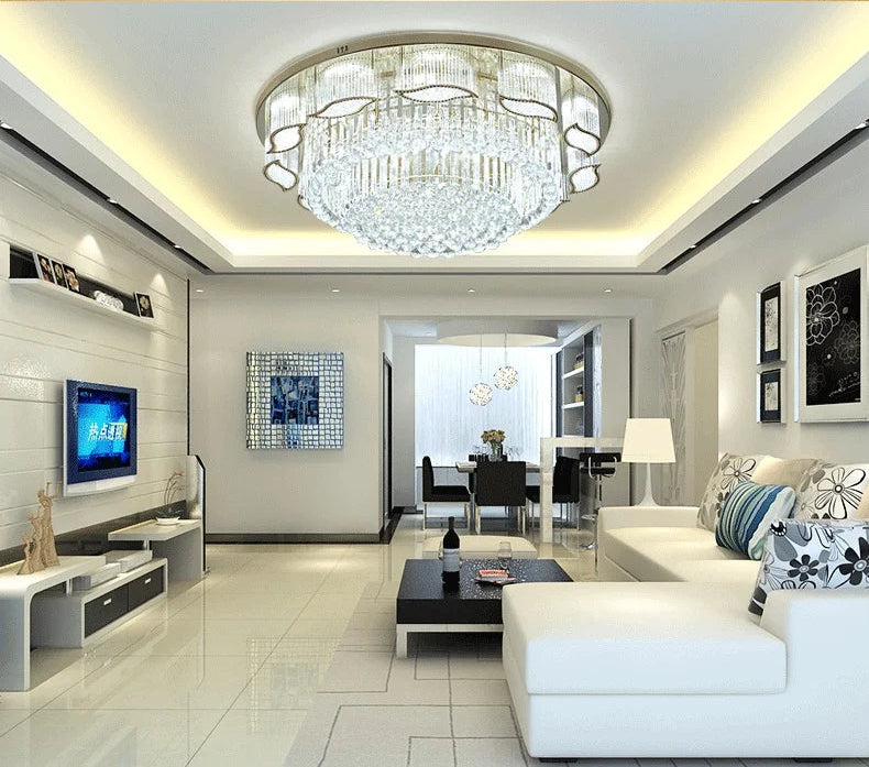 Modern living room with a chandelier, white sofa, and decorative elements.