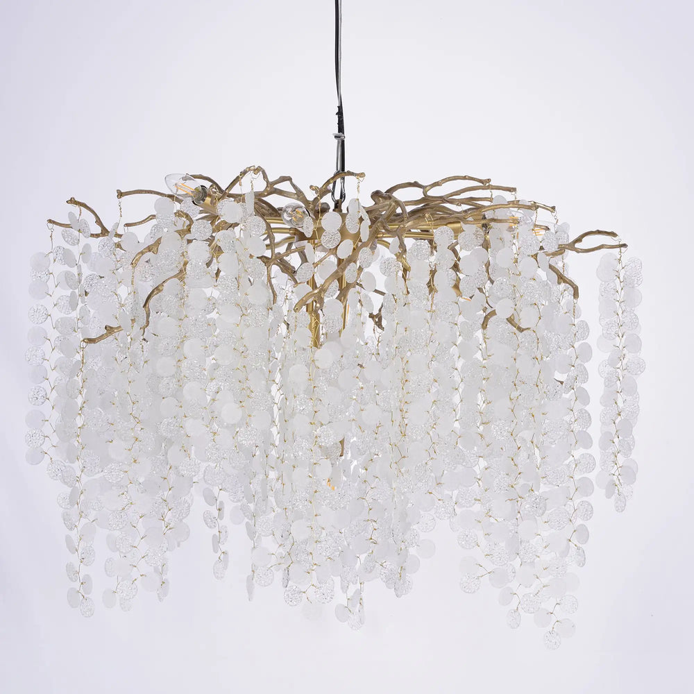 Decorative chandelier with white beads and gold accents on a light gray background