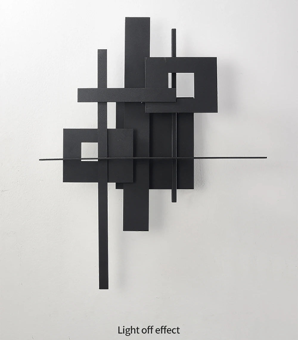 Black abstract wall sculpture on a white background
