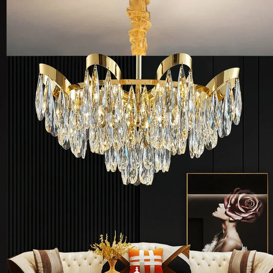 Gold cascading chandelier with teardrop crystals hanging above a living room couch