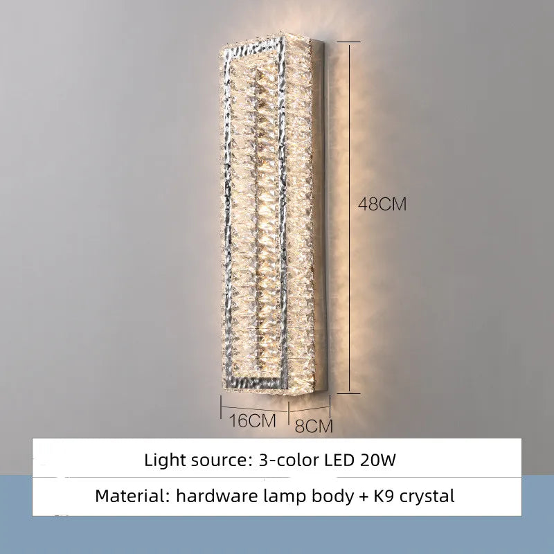Wall-mounted light fixture with crystal design on a gray background