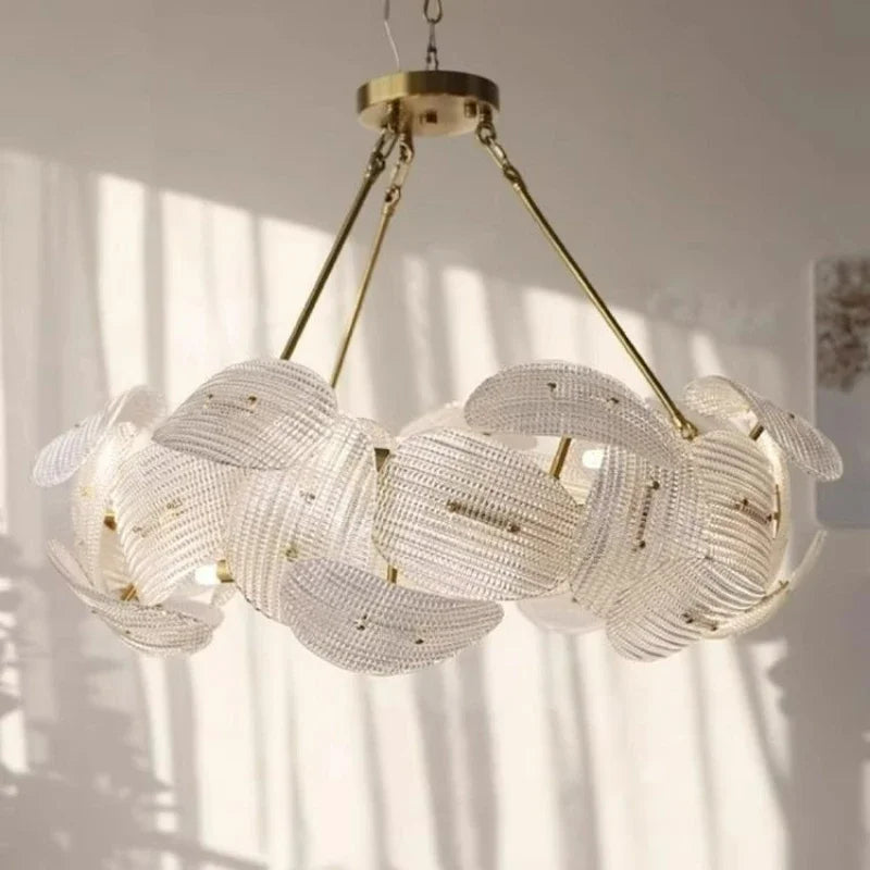 A view of the gold woven floral pendant light showcasing its circular form and the light it casts.
