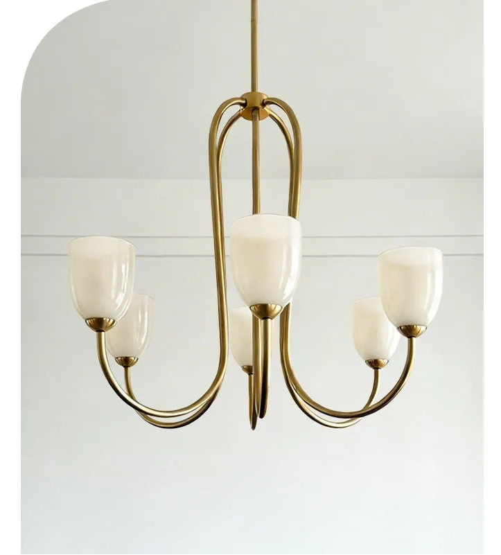 Brushed gold chandelier with white tulip glass shades against a white background.