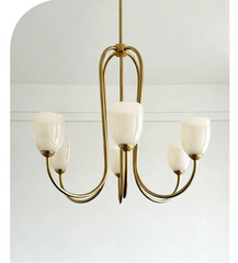 Brushed gold chandelier with white tulip glass shades against a white background.