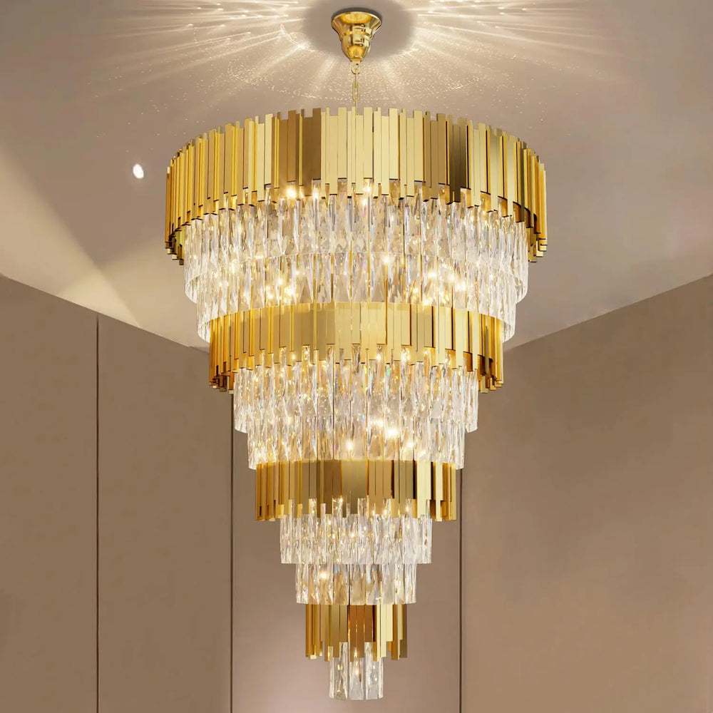 Gold chandelier hanging from a ceiling with a neutral background