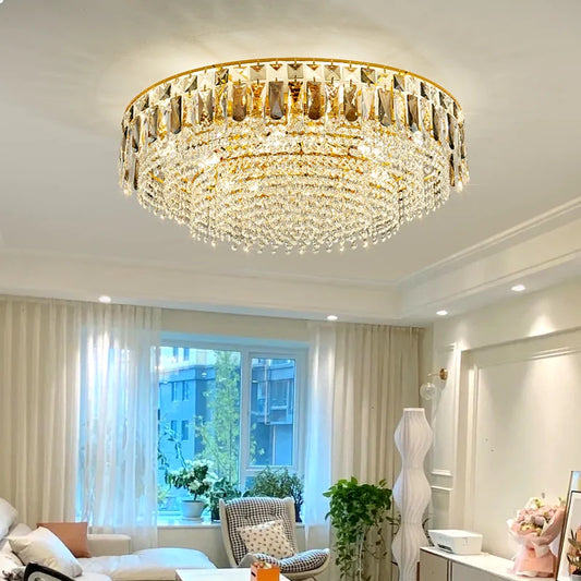 Gold crystal tiered cascading chandelier in a living room setting.