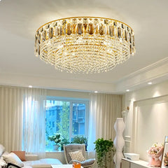 Gold crystal tiered cascading chandelier in a living room setting.