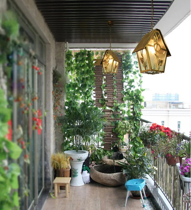 Balcony with plants, a small pond, and decorative lights.