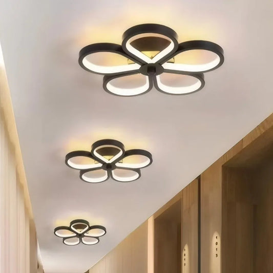 Three black flower-shaped semi-flush mount ceiling lights arranged in a line down a hallway