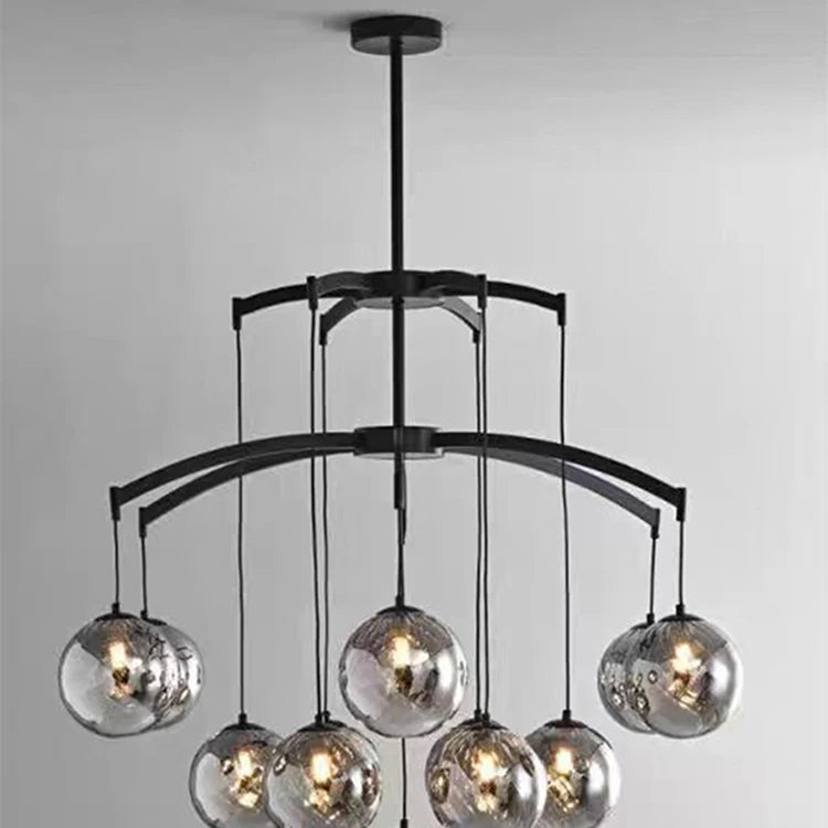 Modern chandelier with glass globe lights on a gray background