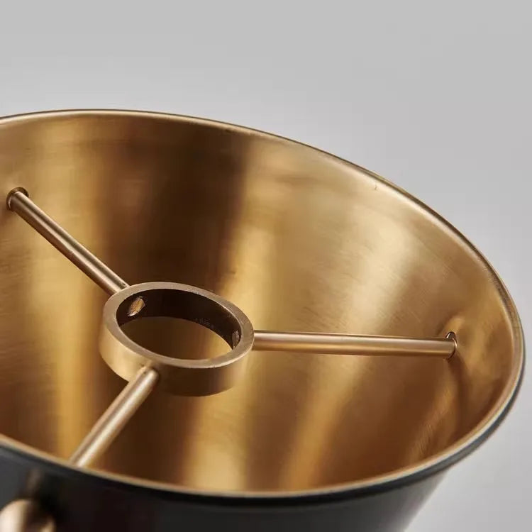 Gold-colored metal component on a gray background