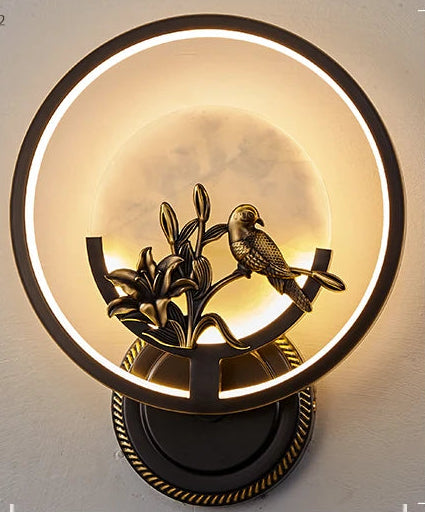 Decorative wall light fixture with bird design on a gray background