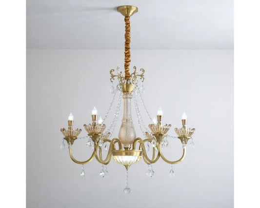 Close-up view of the gold chandelier's arms and central column, showcasing intricate detailing and crystal droplets.