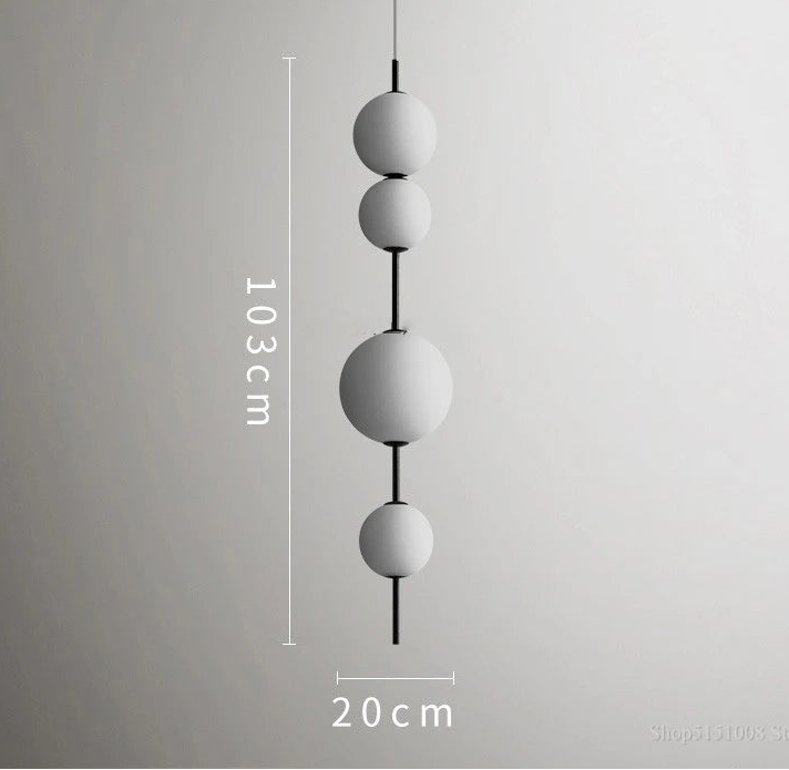 Modern pendant light with three spherical shades on a gray background