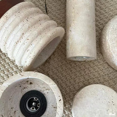 Close-up view of several components of the yellow travertine flush mount light, showing the textured stone and socket.