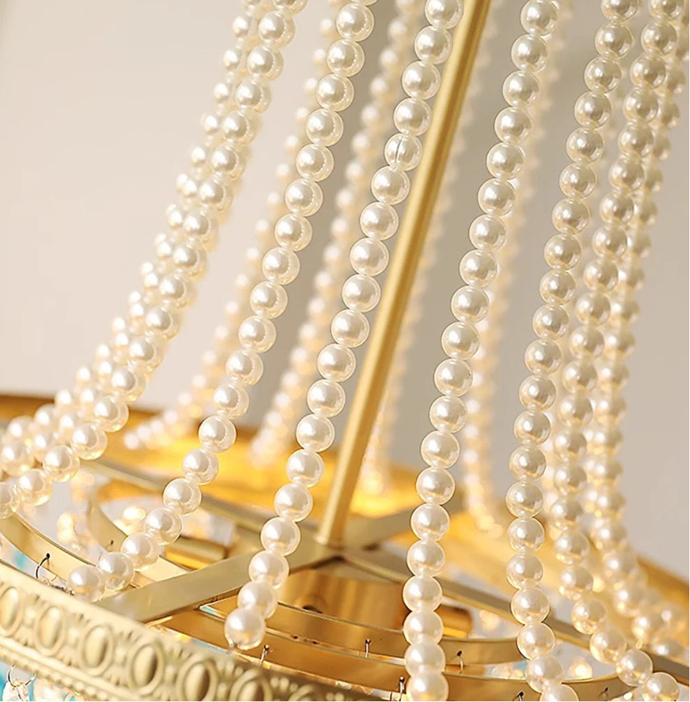 Decorative mirror with pearl-like beads on a light background