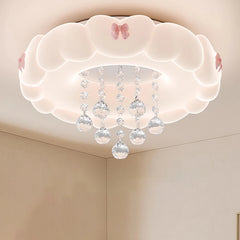 A white cloud-shaped flush mount ceiling light with pink bows and hanging crystal spheres, casting a gentle glow.