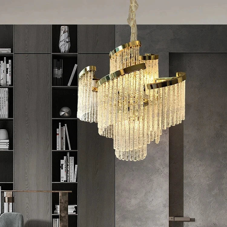 Luxury chandelier hanging in a modern interior setting with a bookshelf in the background.