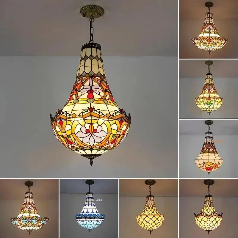 Close-up of a decorative pendant light with stained glass panels in floral patterns and a polished chrome finish, hanging from a chain.