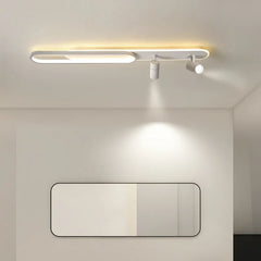 White linear ceiling lamp with an oval accent and two spotlight fixtures casting light downwards onto a rectangular mirror below.