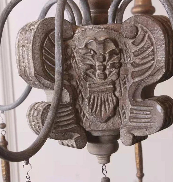 Decorative metal elephant figure with intricate details on a neutral background