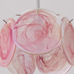 A green floral glass pendant light casting warm, neutral, and white light on the ceiling in a four-panel display.