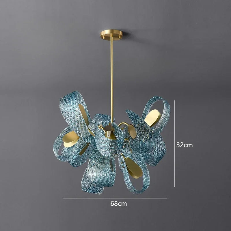 Blue glass chandelier with gold accents on a gray background