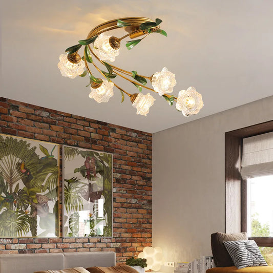 Gold floral semi-flush ceiling light with glass shades mounted on a white ceiling above a brick wall and artwork.