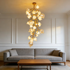 Gold floral chandelier with crystal globes illuminating a living room.