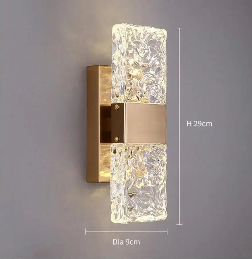 Decorative wall light fixture with crystal design on a gray background