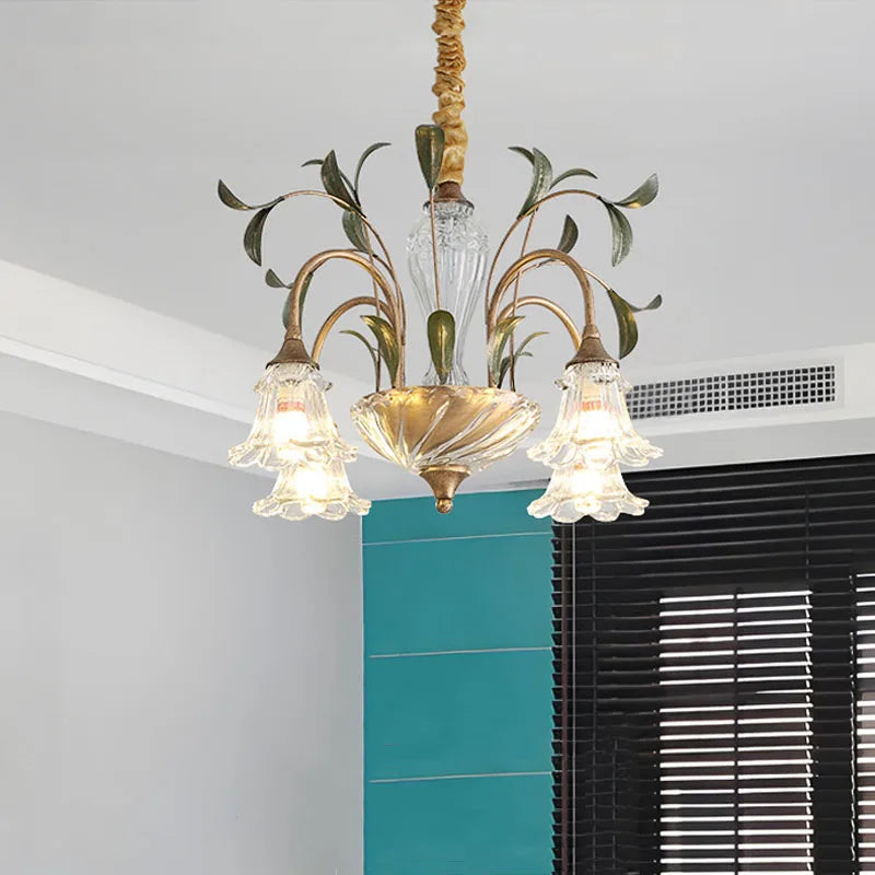 Gold floral crystal semi-flush chandelier in a room with blue accents and blinds