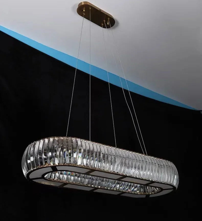 Modern chandelier hanging from a ceiling with a black background