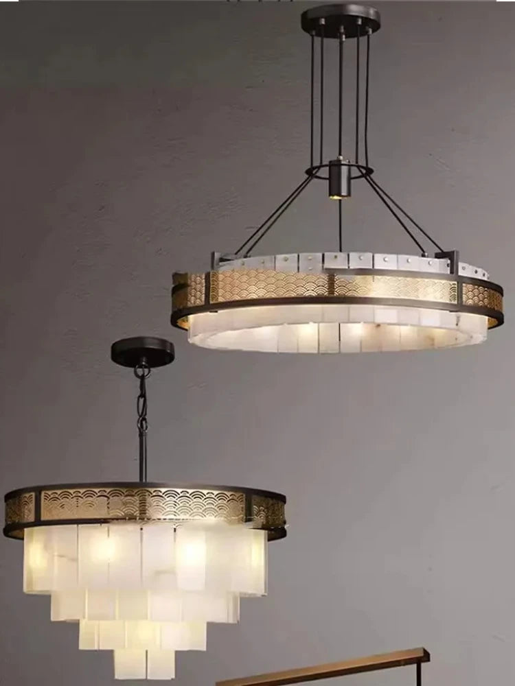 Two chandeliers hanging against a gray background