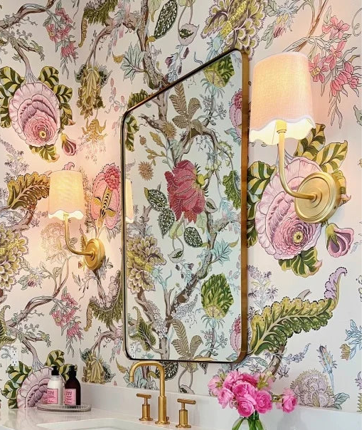 Bathroom with floral wallpaper, vanity, and decorative elements.