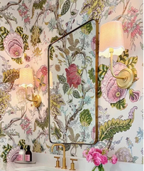 Bathroom with floral wallpaper, vanity, and decorative elements.