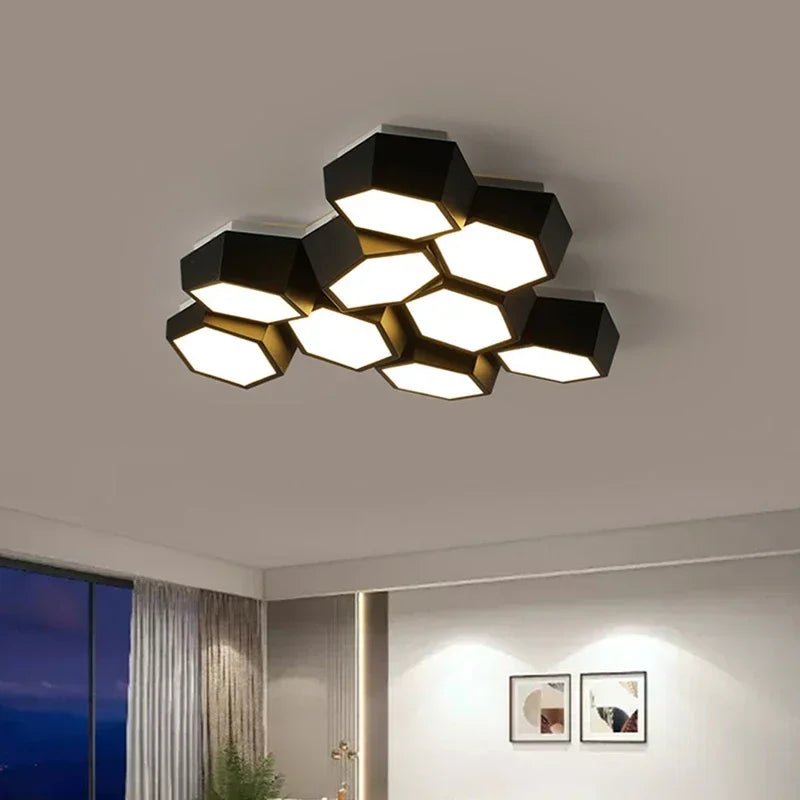 Close-up view of a black geometric cluster ceiling light, showcasing the arrangement of hexagonal panels and the illuminated interior.