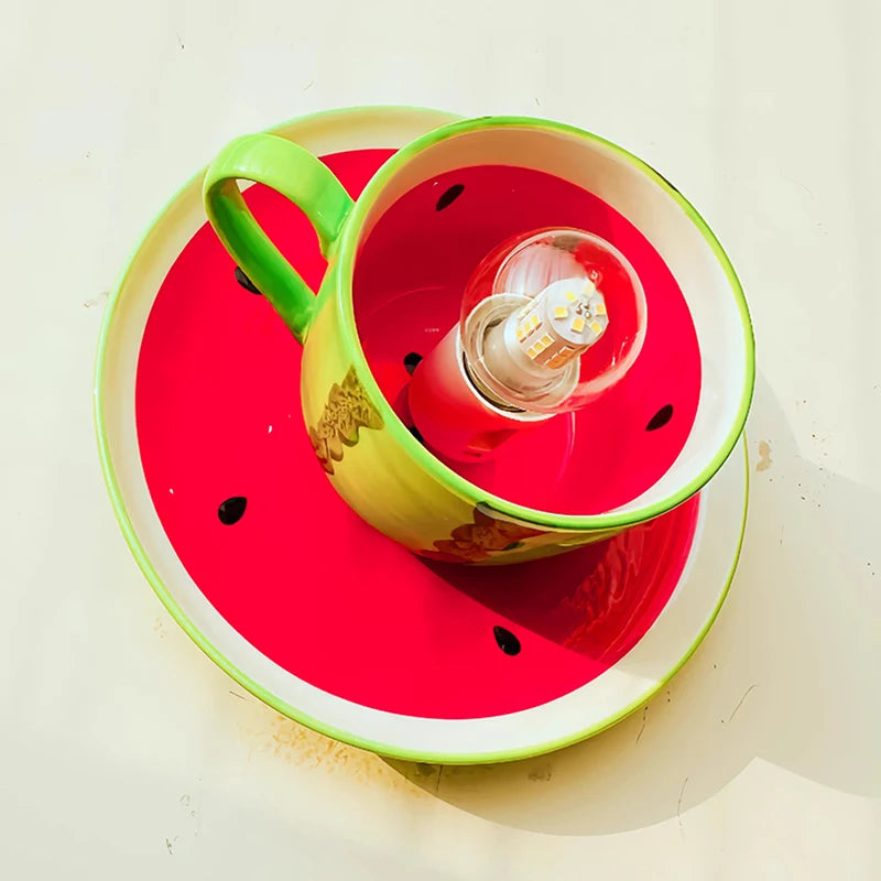Overhead view of the green watermelon ceramic coffee cup ceiling light, looking down into the coffee cup which houses the light bulb, with the watermelon slice base visible below.