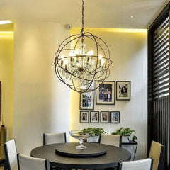 Dining room with a chandelier, round table, and chairs. American vintage iron and crystal pendant lamp for homes.