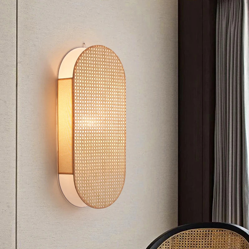 Wall-mounted light fixture with woven design on a neutral wall.