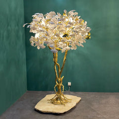 “Large statement lamp with white ceramic leaves and gold base”