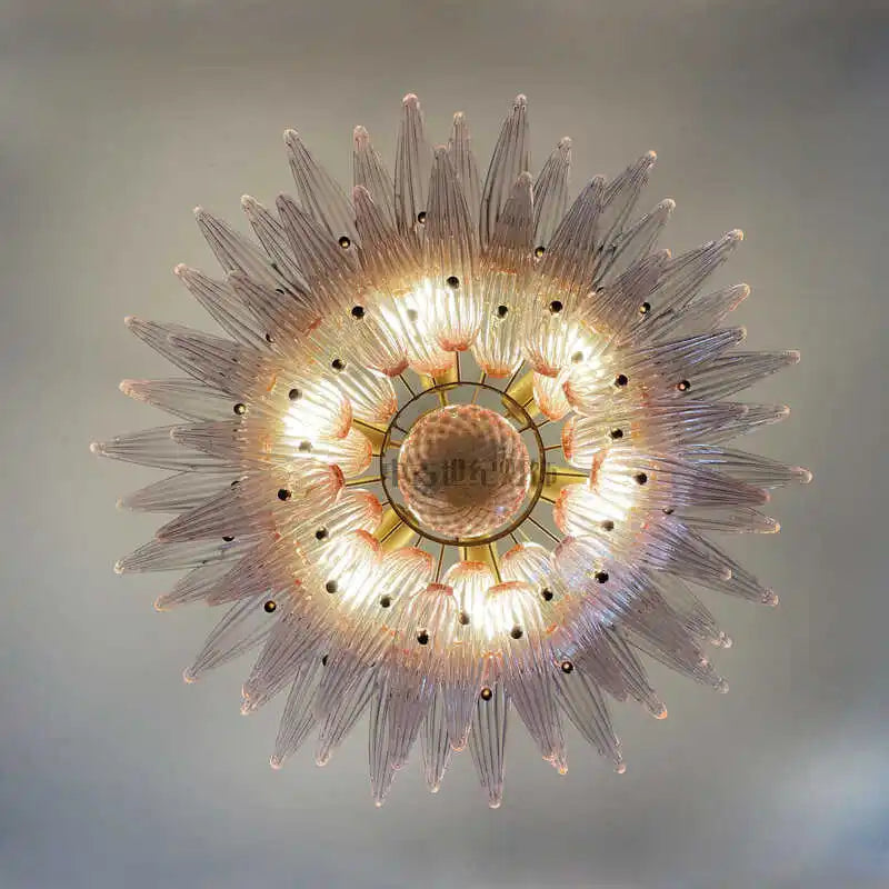 Decorative ceiling light fixture with a starburst design on a neutral background