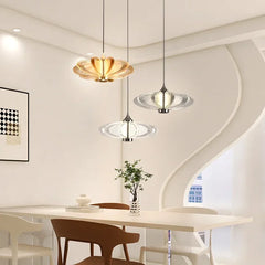 Modern dining room with pendant lights and a table. Artistic glass petal chandelier for contemporary dining and lounge areas