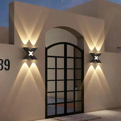 “Modern up-and-down wall sconce casting fan-shaped light patterns.”