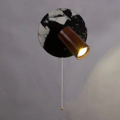 “Bulgari stone wall light with wood shade and gold pull chain”