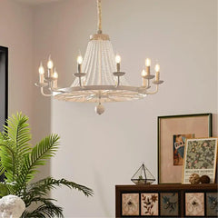 Candle arm chandelier with crystal-style accents installed over dining room ceiling