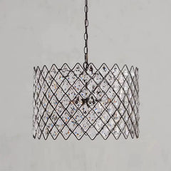 Chain-hung pendant light with faceted crystal for dining spaces