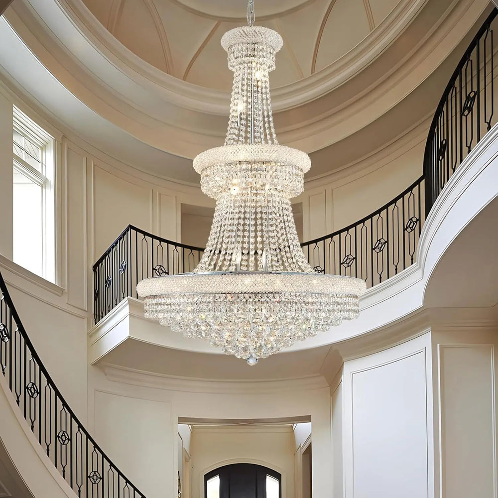 Tiered crystal chandelier with polished chrome finish in a grand stairwell