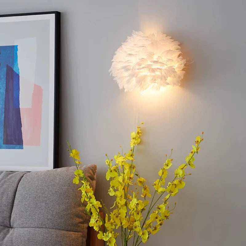 Wall-mounted light fixture with abstract art and a gray sofa in the background