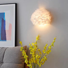 Wall-mounted light fixture with abstract art and a gray sofa in the background